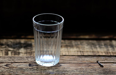 faceted glass empty on the background of wooden boards