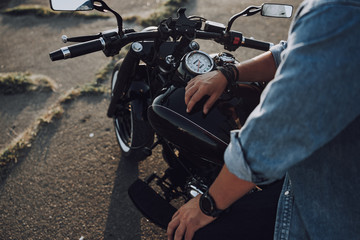 Caucasian guy having rest on his motorbike