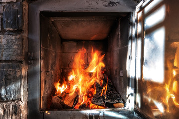 Wood burning in a cozy fireplace at home