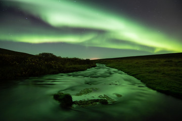 Fototapeta na wymiar Northern lights with reflection in river, North Iceland