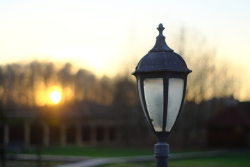Street lamp in a private courtyard at sunset
