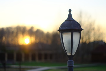 Street lamp in a private courtyard at sunset