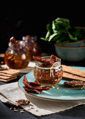 Sun-dried tomatoes with olive oil in a jar of rye bread and a chapel
