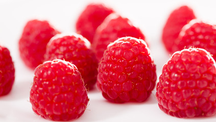 handful of raspberry berries on white background