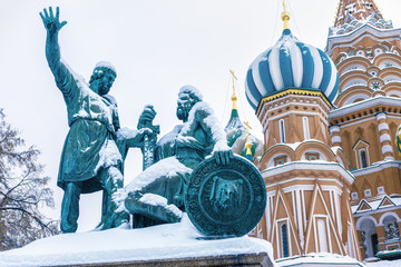 St Basil`s Cathedral and monument to Minin and Pozharsky in winter, Moscow, Russia. Famous Red Square is top tourist attraction of Moscow. Old architecture of the Moscow city center during snowfall.