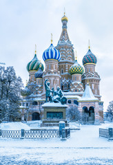 St Basil's cathedral in cold winter, Moscow, Russia. It is a famous landmark of Moscow. Old Red Square during snowfall. Ancient architecture of Moscow under the snow. Concept of Russian frost.