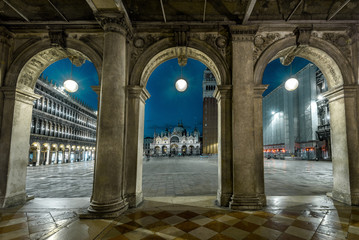 Venice at night, Italy. View to old St Mark`s Square or San Marco. It is a top tourist attraction of Venice. Vintage architecture of Venice at dusk. Scenery of famous Venice city center in evening.