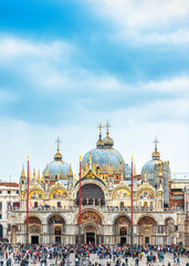 St Mark`s Basilica or San Marco on sky background, Venice, Italy. It is top landmark of Venice. Beautiful medieval cathedral with many people. Ornate architecture of the Renaissance in Venice center.