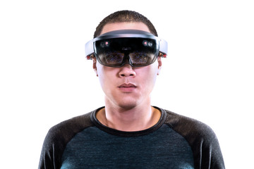 Portrait of young man with 3D virtual reality eye wear glasses hololens. Mixed reality in future advanced technology concept.