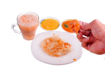 Tea with milk, Roti canai or Roti Parata , dalca and curry sauce on the plate isolated on white background