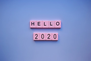 Hello 2020 word wooden cubes on a blue background