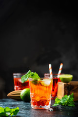 Red fresh cocktail with ice and lime