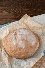 Round homemade bread baked from whole wheat flour. Useful product. The concept of healthy eating.