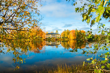Kouvola, Finland - 8 October 2019: Autumn landscape with beautiful wooden Rabbelugn Manor - Takamaan Kartano. Wrede family house was built in 1820 on the river Kymijoki bank.
