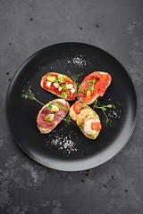 Brusquettes, Assorted, Fish, Prawns, Meat, Vegetables, Seafood, on a black background