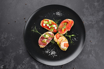 Brusquettes, Assorted, Fish, Prawns, Meat, Vegetables, Seafood, on a black background