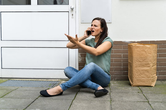 Young Woman Waiting In Front Of Closed Door