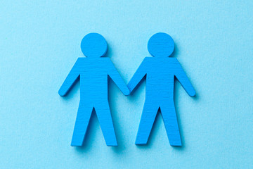 Two GAY men holding hands. On a blue background