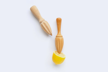 Fresh lemon with two wooden juicer on white