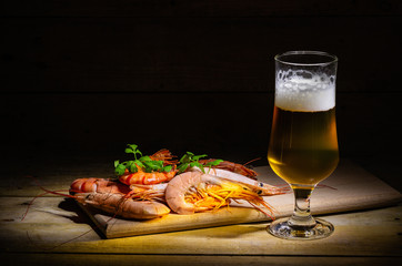 Glass of cold beer with delicious shrimp.