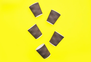 Brown paper coffee cups on abstract colorful background.