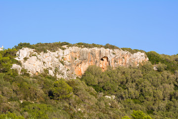 Fototapeta na wymiar Cliffs next to Son Bou Beach in a seaside town in the south of Menorca. Spain