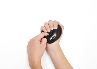 Fototapeta premium Violet slime in child hands on white background.