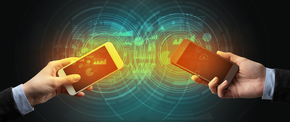 Close up of two smartphones syncing business data