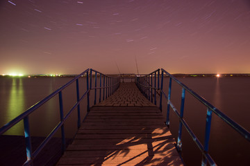 Obraz premium Night bridge, stars and fishing, night landscape