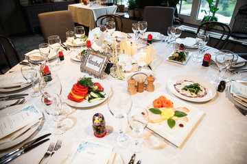 catering at a top event, glasses and flowers on the table, preparation for a significant event, beautiful dishes and glasses on the table, New Year's holiday table