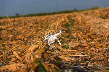 Crashed quad copter in park. Propeller damage.Accident with a drone.High angle view of broken drone on grass field. Some crashed drone.