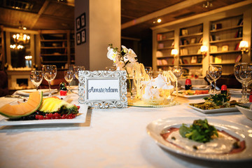 catering at a top event, glasses and flowers on the table, preparation for a significant event, beautiful dishes and glasses on the table, New Year's holiday table