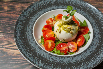 Salad made of  baby mozzarella, arugula and cherry tomato