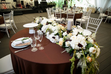 catering at a top event, glasses and flowers on the table, preparation for a significant event, beautiful dishes and glasses on the table, New Year's holiday table