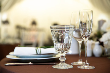 catering at a top event, glasses and flowers on the table, preparation for a significant event, beautiful dishes and glasses on the table, New Year's holiday table