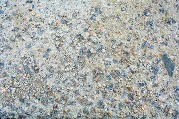 Ground street surface of broken asphalt or cement with pothole and stone pebbles. Damaged concrete road sidewalk with old dangerous pothole. Urban texture of old stone floor