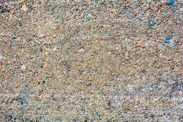 Texture of old rough surface of cement or concrete with large fractions of sand and stones. Urban cement weathered wall or floor of city building