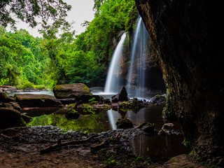 Fototapeta na wymiar Haew Suwat Waterfall Khao Yai National Park, Nakhon Ratchasima, Thailand Waterfall view from the inside of the cave