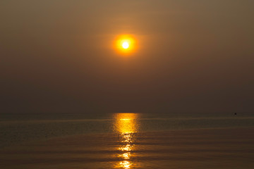 Fototapeta premium The blue sea in the morning with the rising sun