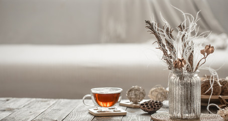 home decor beautiful vase with flowers and a Cup of tea.