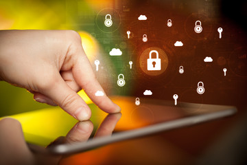 Hand holding tablet with online security system concept