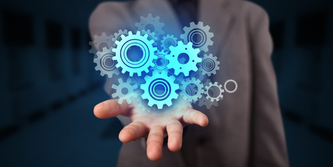 Hand holding gears in his hand