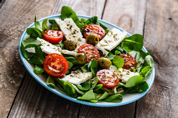 Greek salad on wooden background