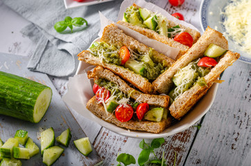 Healthy toast with vegetables, pesto and cheese
