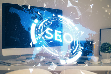 Multi exposure of table with computer and seo drawing hologram. Search optimization concept.