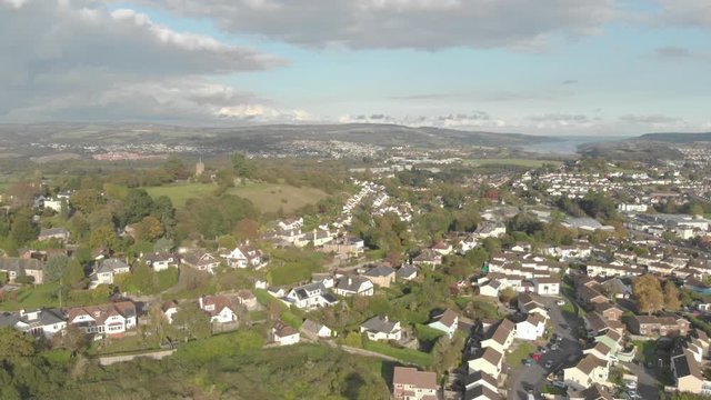 Town of Newton Abbot (Devon, UK), aerial drone footage showing buildings & church on hilltop