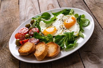 Breakfast - fried egg ,toasts and vegetabla salad
