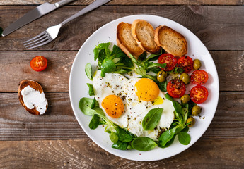 Breakfast - fried egg ,toasts and vegetabla salad