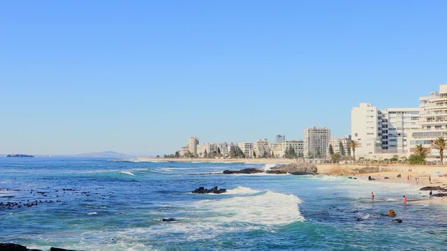 Surfers catching waves at Sea Point promenade on the Atlantic Seaboard of Cape Town South Africa