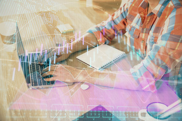 Multi exposure of forex graph with man working on computer on background. Concept of market analysis.